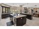 Contemporary kitchen with island seating, stone countertops, and access to an outdoor patio at 26049 N 104Th Pl, Scottsdale, AZ 85255