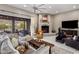 Cozy living room with fireplace, plush seating, and natural light at 26049 N 104Th Pl, Scottsdale, AZ 85255