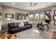Large living room featuring many windows and a leather sofa, and adjacent office space at 26049 N 104Th Pl, Scottsdale, AZ 85255