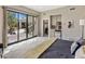 Bedroom with patio access, view of backyard, and a convenient kitchenette at 26049 N 104Th Pl, Scottsdale, AZ 85255
