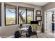 Bright office space featuring multiple windows with views of the yard and desert landscape at 26049 N 104Th Pl, Scottsdale, AZ 85255