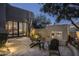 Charming outdoor fireplace with stone patio and comfortable seating, surrounded by desert landscaping at 26049 N 104Th Pl, Scottsdale, AZ 85255