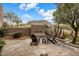 Cozy outdoor patio with a modern fireplace, comfortable seating, and desert landscaping, perfect for evening relaxation at 26049 N 104Th Pl, Scottsdale, AZ 85255