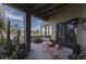Covered patio with dining set and desert views from the backyard at 26049 N 104Th Pl, Scottsdale, AZ 85255