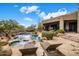 Backyard pool area featuring a stone deck, hot tub, and outdoor furniture at 26049 N 104Th Pl, Scottsdale, AZ 85255
