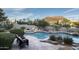 A relaxing pool area with lush landscaping and a mountain view at 26049 N 104Th Pl, Scottsdale, AZ 85255