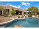 Backyard pool featuring mature landscaping and patio with outdoor dining and lounging furniture at 26049 N 104Th Pl, Scottsdale, AZ 85255