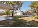 Backyard features a covered patio, detached garage, privacy fence, and mature trees at 2740 N 21St Dr, Phoenix, AZ 85009