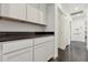 Hallway featuring white cabinets and countertops with a seamless design and access to multiple rooms at 2740 N 21St Dr, Phoenix, AZ 85009