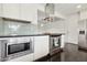 Well-equipped kitchen featuring stainless appliances, sleek white cabinets, and modern fixtures at 2740 N 21St Dr, Phoenix, AZ 85009
