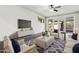 Elegantly furnished living room featuring modern decor, a plush rug, and a large TV for entertainment at 2740 N 21St Dr, Phoenix, AZ 85009