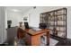 Functional home office with stylish wooden desk, shelving and dark floors at 2740 N 21St Dr, Phoenix, AZ 85009