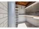 Storage room featuring shelving, concrete block walls, and concrete flooring, offering versatile usage at 2740 N 21St Dr, Phoenix, AZ 85009