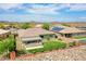 Aerial view of a home featuring a backyard with an outdoor kitchen, green turf, and desert landscaping at 30909 N 27Th Ave, Phoenix, AZ 85085