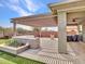 Backyard oasis featuring desert landscaping, a covered pergola, built in grill, and hot tub at 30909 N 27Th Ave, Phoenix, AZ 85085