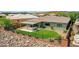 Private backyard oasis with synthetic grass, covered patio, and privacy fence in a desert landscape at 30909 N 27Th Ave, Phoenix, AZ 85085