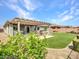 Enjoy the desert landscape with the green turf, built-in grill, patio, and spa in the backyard at 30909 N 27Th Ave, Phoenix, AZ 85085
