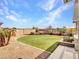 Lush backyard with well-manicured lawn, desert landscaping, and gravel ground cover at 30909 N 27Th Ave, Phoenix, AZ 85085