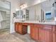 Bright bathroom featuring double vanity, stylish mirrors, tile floors and walk-in closet at 30909 N 27Th Ave, Phoenix, AZ 85085