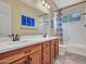This bathroom features double sinks, wood cabinets, and shower-tub combo at 30909 N 27Th Ave, Phoenix, AZ 85085