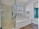 Modern bathroom featuring a glass shower and relaxing soaking tub at 30909 N 27Th Ave, Phoenix, AZ 85085