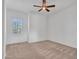 Neutral bedroom featuring a ceiling fan, window with shutters, and plush carpet at 30909 N 27Th Ave, Phoenix, AZ 85085