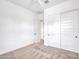Well-lit bedroom featuring a closet, neutral carpet, and clean decor at 30909 N 27Th Ave, Phoenix, AZ 85085