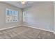 Sunlit bedroom featuring large windows with shutters and neutral decor at 30909 N 27Th Ave, Phoenix, AZ 85085