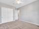 Bright bedroom featuring a fan, neutral carpet, and a closet at 30909 N 27Th Ave, Phoenix, AZ 85085