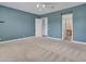 Large bedroom features neutral carpet, ceiling fan, recessed lights and light blue accent wall at 30909 N 27Th Ave, Phoenix, AZ 85085