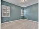 Comfortable carpeted bedroom with two bright windows and neutral accents at 30909 N 27Th Ave, Phoenix, AZ 85085