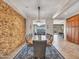 Bright dining room featuring a stone accent wall, chandelier, and access to the living spaces at 30909 N 27Th Ave, Phoenix, AZ 85085