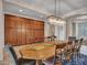 Elegant dining room featuring a long wooden table, seating for ten, and a crystal chandelier at 30909 N 27Th Ave, Phoenix, AZ 85085