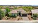 Beautiful single-story home with a well-manicured front yard, desert landscaping, and a two-car garage at 30909 N 27Th Ave, Phoenix, AZ 85085