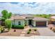 Stunning single-story home featuring a well-manicured front yard and a two-car garage with brick paver driveway at 30909 N 27Th Ave, Phoenix, AZ 85085