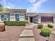 Charming single-story home featuring desert landscaping, stone walkway and a two-car garage at 30909 N 27Th Ave, Phoenix, AZ 85085