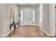 Inviting foyer featuring tile flooring, a decorative table with ornate mirror, and arched doorway at 30909 N 27Th Ave, Phoenix, AZ 85085