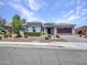 Well maintained single-story home with desert landscaping, walkway, and attached garage at 30909 N 27Th Ave, Phoenix, AZ 85085