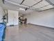 Spacious garage with epoxy floors and ample room for storage with attached shelving and a storage area beyond at 30909 N 27Th Ave, Phoenix, AZ 85085