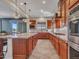 Spacious kitchen with granite countertops, wooden cabinets, stainless steel appliances, and kitchen island at 30909 N 27Th Ave, Phoenix, AZ 85085