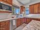 Kitchen with stainless steel appliances, granite countertops, wooden cabinets, and a view from the window at 30909 N 27Th Ave, Phoenix, AZ 85085