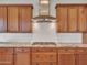 Close up shot of a kitchen featuring wooden cabinets, granite countertops, and stainless steel appliances at 30909 N 27Th Ave, Phoenix, AZ 85085