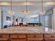 A view of the kitchen island with granite countertops and a peek into the living room beyond at 30909 N 27Th Ave, Phoenix, AZ 85085