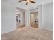 Open-concept living room with plush carpet flooring and multiple entryways showcasing the home's layout at 30909 N 27Th Ave, Phoenix, AZ 85085