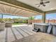 Outdoor patio featuring built in grill, hot tub, and travertine tile at 30909 N 27Th Ave, Phoenix, AZ 85085