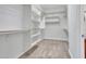 Well-organized walk-in closet with white shelving and carpet at 30909 N 27Th Ave, Phoenix, AZ 85085