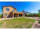 Backyard featuring a green lawn, brick pavers, and covered patio, ideal for outdoor living at 31604 N 19Th Ave, Phoenix, AZ 85085