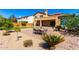 View of the backyard featuring desert landscaping, green grass, covered patio and dining table at 31604 N 19Th Ave, Phoenix, AZ 85085