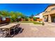 A spacious backyard with neutral colors features a dining table on brick pavers at 31604 N 19Th Ave, Phoenix, AZ 85085
