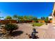 A spacious backyard featuring desert landscaping and a square plot of green grass at 31604 N 19Th Ave, Phoenix, AZ 85085